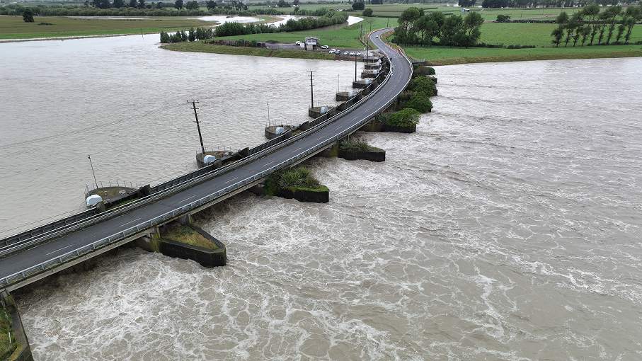A view of a bridge while a river is rising 